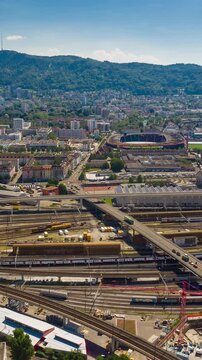 flight over zurich railway traffic sunny day city stadium aerial vertical panorama 4k timelapse switzerland 