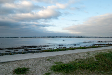 A beach with a cloudy sky in the background