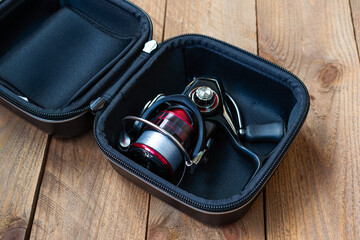 Fishing reel in an open case