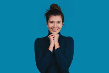 joyful woman portrait, female model in relaxed pose wearing casual clothes and smiling warmly