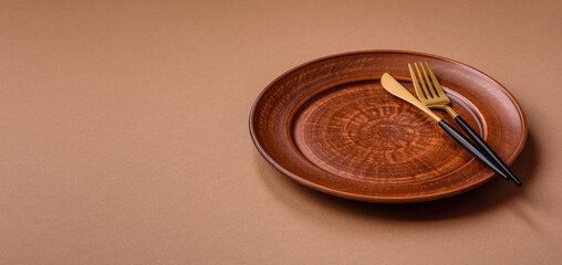 An empty round ceramic plate on a table, kitchenware. An empty plate