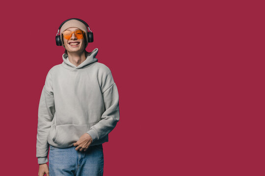 happy casual photograph, image showcasing laidback style with sunglasses and headphones in vibrant setting