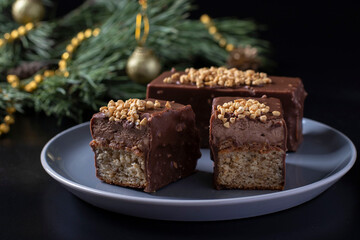 Sliced mousse desserts with hazelnut praline, milk chocolate and covered gourmet chocolate-nut glaze on gray plate