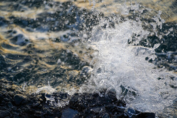 A wave breaking at a rock	