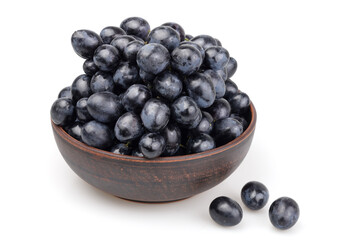 Moldova grapes in a clay bowl against a white background. In Europe, this variety is also known as Moldovan Black.