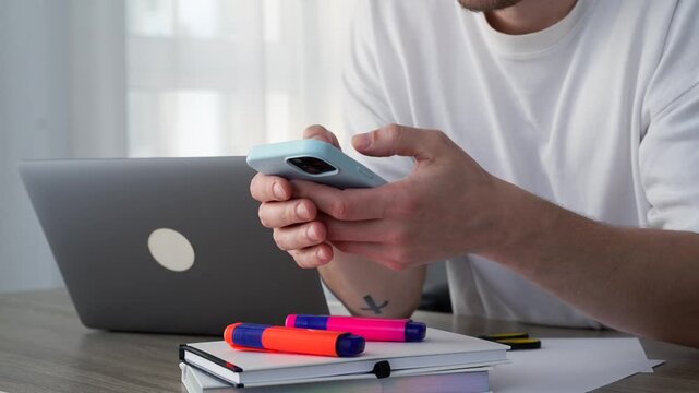 Online communication with clients.
Chatting and online consultation.
A guy sitting at his desk with a phone in his hand.
Smartphone, gadget, technology, call, messaging, PIN code