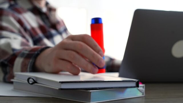 A young man holds a pink highlighter while sitting at his desk in an office.
Important information in documents.
Highlighter, office, desk, paperwork, business, texting, typing