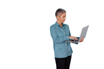 Senior woman actively working on a laptop, standing and typing, demonstrating professional dedication, with a transparent background