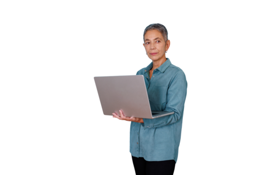 Senior businesswoman standing, working on laptop, confident and focused while using technology for professional tasks - Powered by Adobe