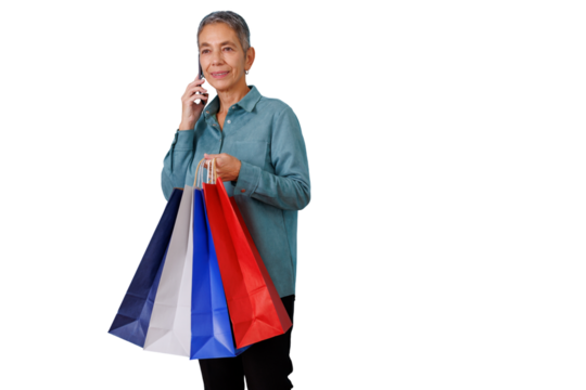 Mature woman shopping, holding colorful bags and talking on mobile phone, enjoying modern retail experience on transparent background