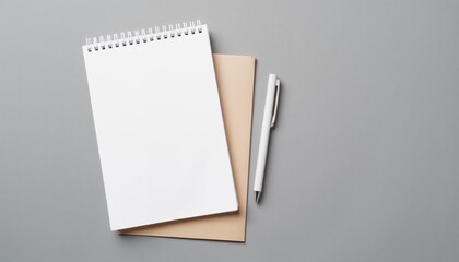 Blank notebook and pen on gray background for creative ideas with copy space