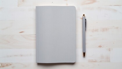 Gray notebook and pen on a light wooden surface with copy space 