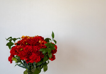 bouquet of red flowers on white background, with negative space
