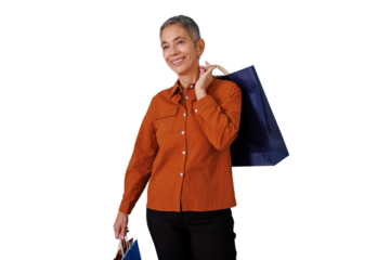Senior woman smiling, carrying shopping bags on a transparent background, depicting consumerism, sales, and retail
