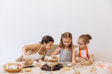 Children learning pottery craft creating clay artwork