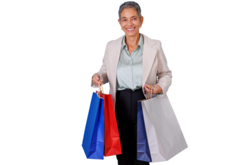 Happy senior woman expressing joy while holding multiple shopping bags, enjoying a successful day fulfilling consumer needs