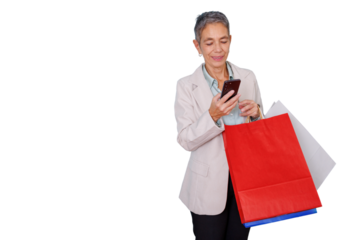 Senior woman shopping online using smartphone and carrying colorful bags, retail experience, happy customer