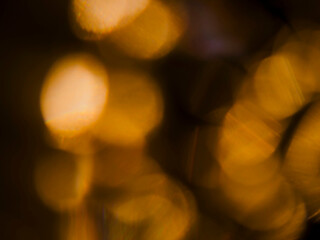 Colorful warm yellow light leak on a black background for design and special effects. Random shape and form.