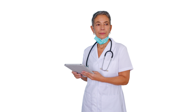 Senior medical professional holding a tablet with a face mask around her neck, standing against a transparent background