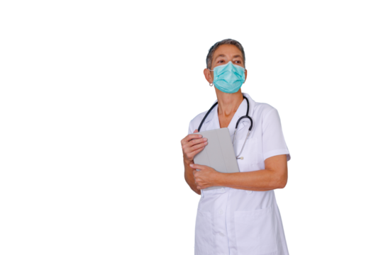 Mature female doctor wearing face mask and stethoscope holding digital tablet, looking away