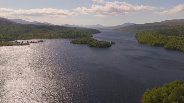 flying over the north end of Loch Garry in Scotland looking out over the water down the full length of the loch toward the mountains of Sg&ugrave;rr na C&igrave;che