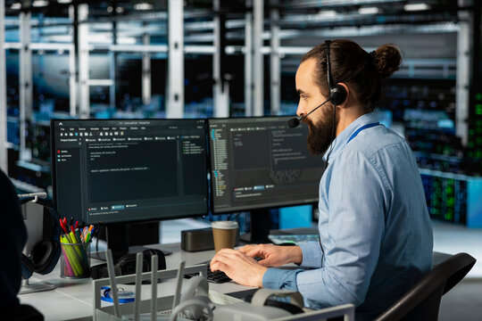 Man doing tech support in server room, managing large scale IT infrastructure rackmounts. Data center admin speaking in headset mic, deploying servers and doing maintenance on network hardware