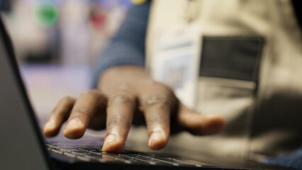 Close up of smart factory worker using laptop to test automated systems, monitoring production metrics. Industry 4.0 plant expert inspecting machinery to identify and fix malfunctions, camera B