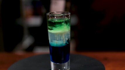 Close up of bartender making layered shots with liqueurs. High quality 4k footage