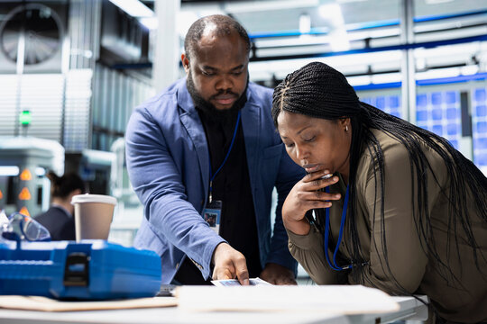 Solar energy specialists and business associates engaging in a strategy meeting on the production line, aligning corporate goals with renewable power engineering innovations. Photovoltaics.