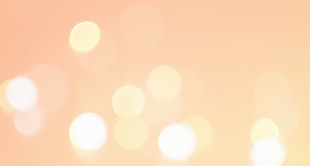 淡いオレンジ色の玉ボケの写真　抽象的な光の背景装飾　エフェクト
