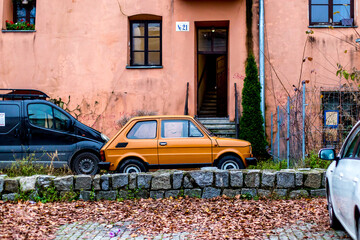 Iconic Polish Fiat 126p 'Maluch' Car Parked on Cobblestone Street in Lublin Old Town, Poland