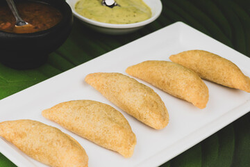 Colombian empanada with spicy sauce 