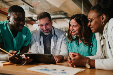 Diverse medical team collaborating on digital tablet