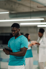 Male nurse using digital tablet in hospital