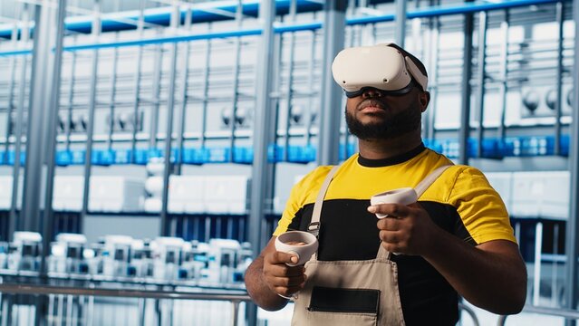 Engineer using virtual reality tech in industry 4.0 solar panels plant producing renewable energy. Technician in photovoltaics smart factory analyzing data using VR headset, camera A