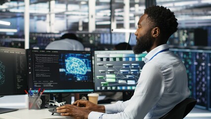 Server hub engineering team interprets AI generated data analytics graphs. Teamworking data center colleagues using artificial intelligence program showing predictive system metrics, camera B