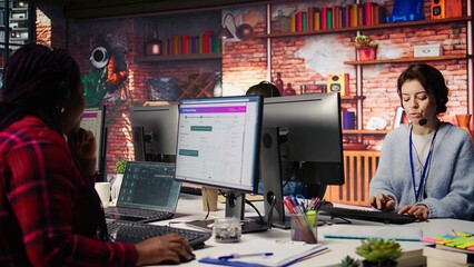 Customer support workers doing upselling, recommending products to clients during conversation. Call center agents contact prospects to inform them about new services and promotions, camera B close up