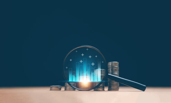 Financial analysis concept. Stacked coins and a magnifying glass showing rising bar charts and growth indicators. Representing investment performance, market trends and economic insight.