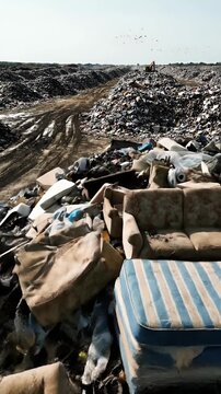 Aerial View Of A Vast Landfill With Piles Of Discarded Furniture And Trash