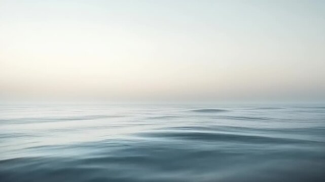 Minimalist ocean view presenting the tranquil vastness of calm waters meeting a soft, ethereal horizon under a gradient sky, evoking serene peace and natural beauty