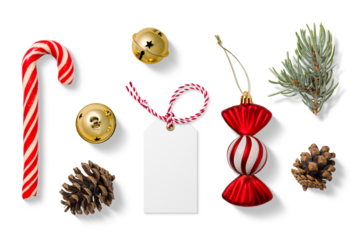 Collection of Christmas-themed elements on a transparent background, featuring a red and white candy cane, gold jingle bells, spruce branches, pine cones, a blank gift tag and festive candy ornament. 