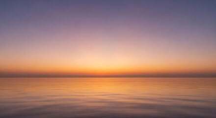 Serene seascape illuminated by soft hues of dawn or sunset horizon