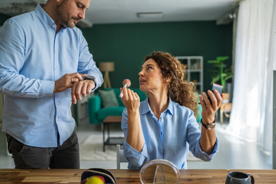 Husband feeling impatient while wife doing morning makeup routine