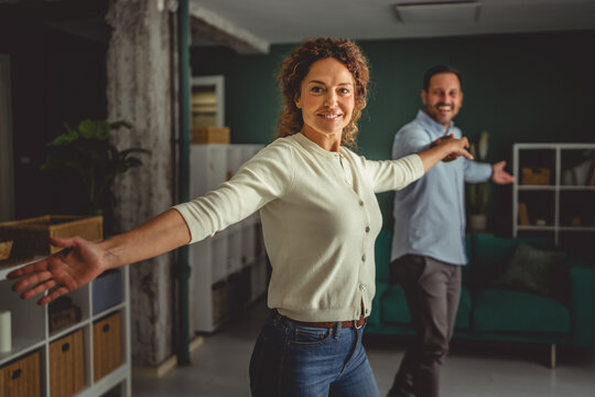 Couple dancing joyful together at home