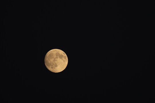 A detailed photograph of the waxing gibbous moon captured on October 5, 2025, at 7:01 p.m., showing bright lunar surface features against a dark night sky.