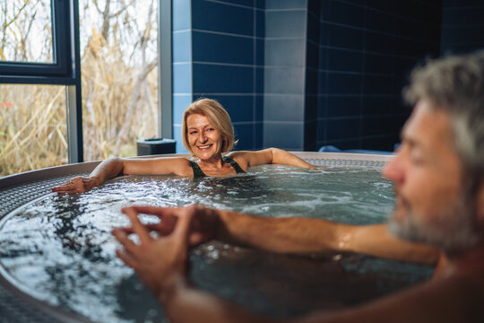 Senior couple enjoying spa relaxation in a bubbling jacuzzi