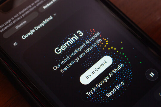 Quito, ECUADOR - Nov 21 2025 :Close-up of Google DeepMind Gemini 3 promotional website with vibrant dotted graphics and interactive buttons.