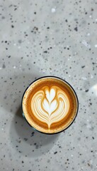 Latte Art Heart on Grey Speckled Surface with Copy Space - Freshly Brewed Coffee Drink for Backgrounds and Templates