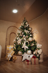 Christmas tree with gifts and lights inside a house