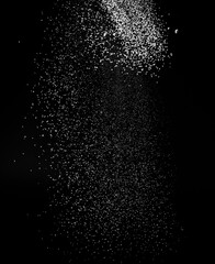 Freezing falling particles or stardust in air on black background for overlay blending mode. Stopping the movement of white powder on a dark background, selective focus, wide banner